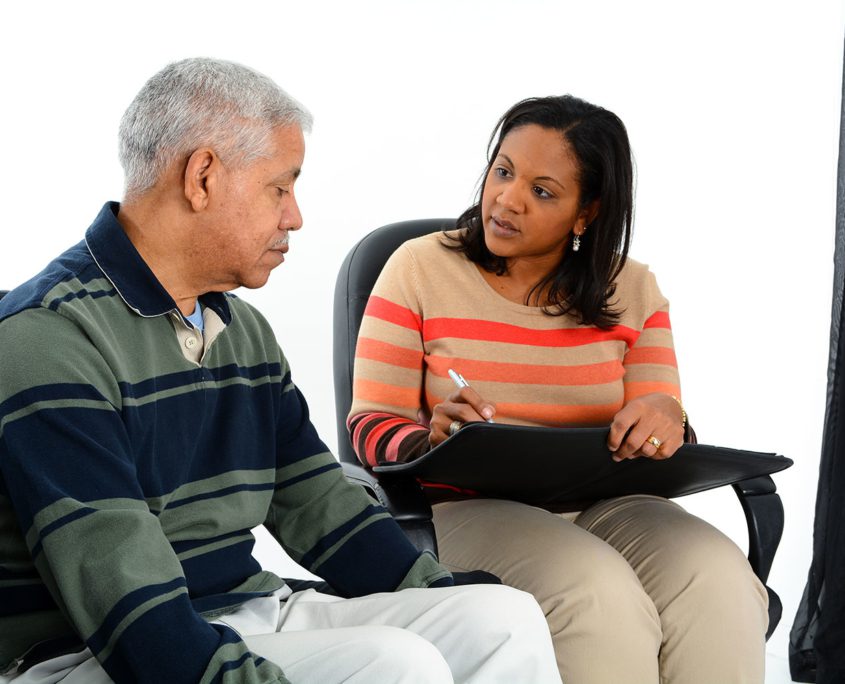 Younger woman counseling older man