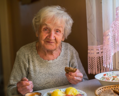 Older adult woman eating meal